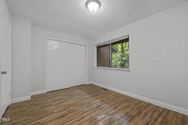 1131 Schaub Dr, Raleigh, NC 27606 - unfurnished bedroom with wood finished floors, baseboards, and a closet