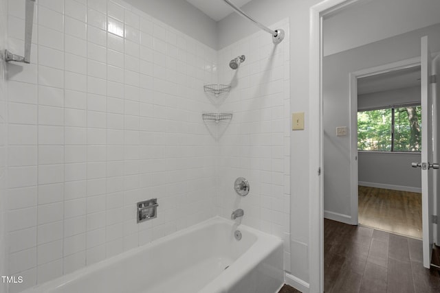 1131 Schaub Dr, Raleigh, NC 27606 - bathroom with wood finished floors, shower / tub combination, and baseboards