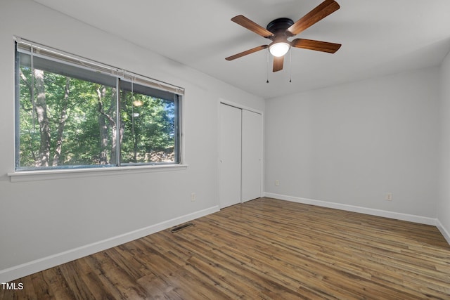 1131 Schaub Dr, Raleigh, NC 27606 - unfurnished bedroom featuring multiple windows, wood finished floors, and baseboards