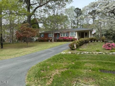5517 Spring Rd, Raleigh, NC 27603 - ranch-style home with asphalt driveway and a front yard