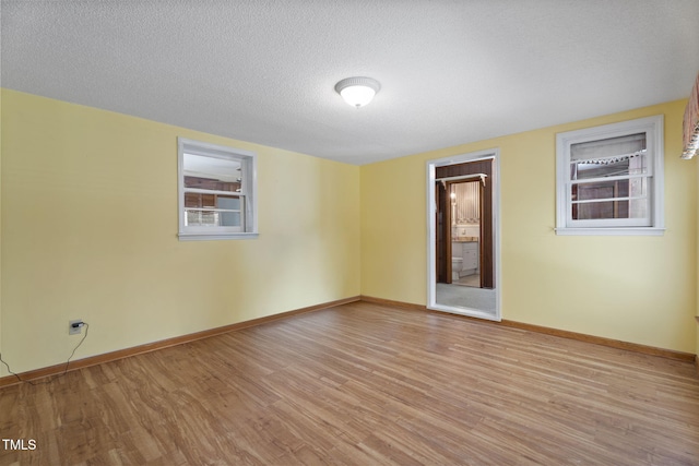 5517 Spring Rd, Raleigh, NC 27603 - spare room with wood finished floors, baseboards, and a textured ceiling