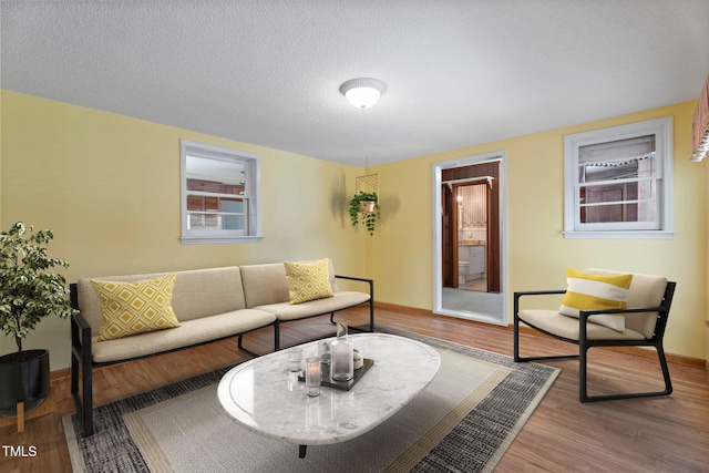 5517 Spring Rd, Raleigh, NC 27603 - living room with wood finished floors, baseboards, and a textured ceiling