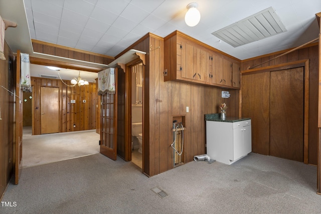 5517 Spring Rd, Raleigh, NC 27603 - basement with carpet flooring, a chandelier, and wood walls