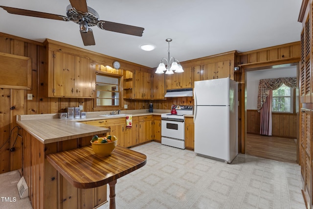 5517 Spring Rd, Raleigh, NC 27603 - kitchen featuring white appliances, under cabinet range hood, open shelves, wooden walls, and light floors