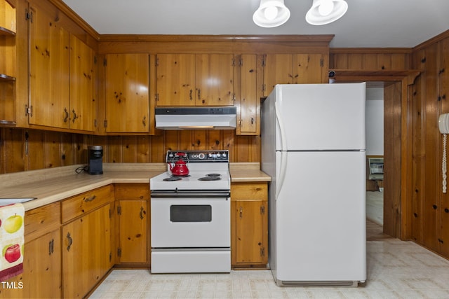 5517 Spring Rd, Raleigh, NC 27603 - kitchen with white appliances, under cabinet range hood, light countertops, light floors, and brown cabinetry