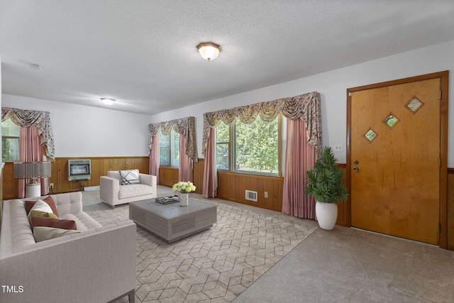 5517 Spring Rd, Raleigh, NC 27603 - living area featuring wood walls, light colored carpet, wainscoting, and a textured ceiling