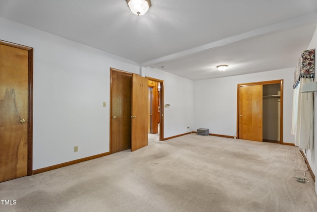 5517 Spring Rd, Raleigh, NC 27603 - unfurnished bedroom featuring baseboards and light carpet