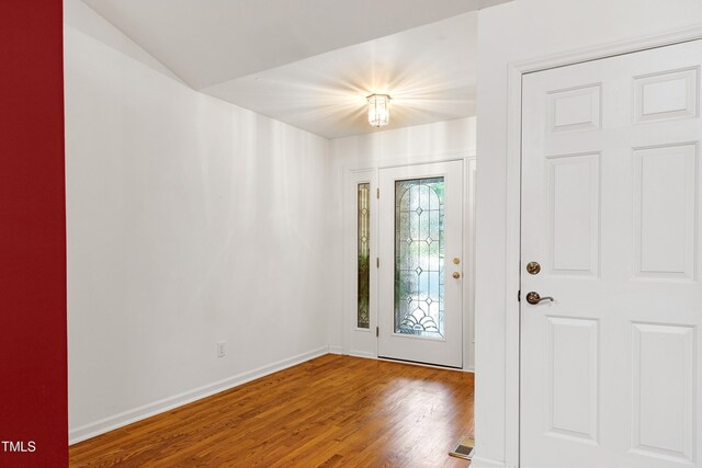 foyer entrance featuring wood finished floors and baseboards