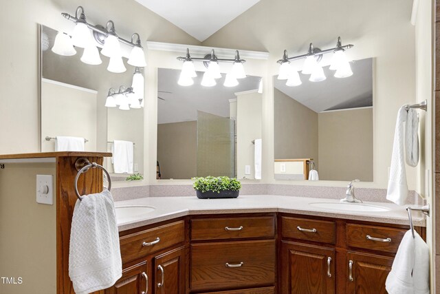 bathroom featuring double vanity and lofted ceiling