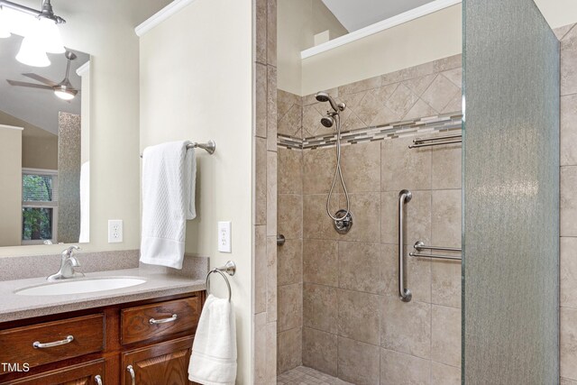 bathroom with a stall shower, vanity, and a ceiling fan