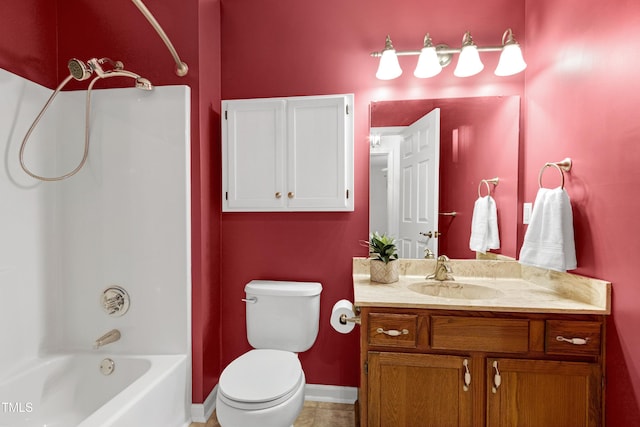 bathroom featuring shower / bath combination, toilet, vanity, baseboards, and tile patterned floors