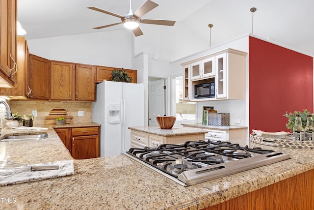 kitchen with white fridge with ice dispenser, gas cooktop, a sink, a ceiling fan, and black microwave