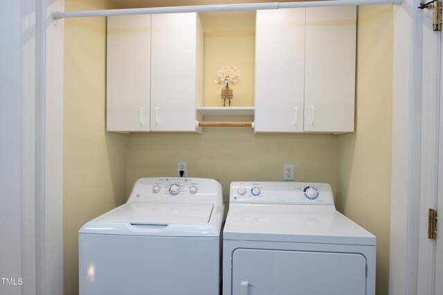 washroom with cabinet space and washing machine and dryer