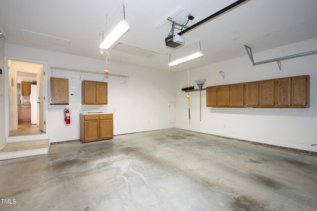 garage with a garage door opener and freestanding refrigerator