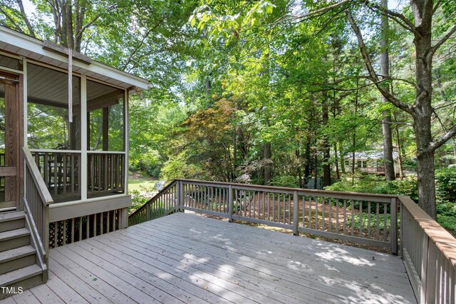 wooden terrace featuring a sunroom