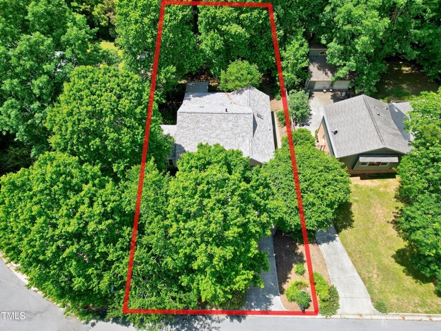 aerial view of property and surrounding area featuring property parcel outlined