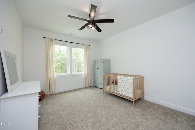 2200 Mays Crossroads Rd, Louisburg, NC 27549 - unfurnished bedroom with carpet floors, baseboards, a nursery area, and ceiling fan