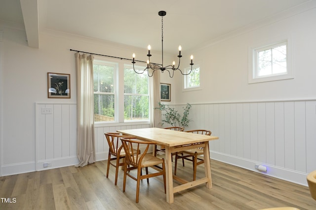 2200 Mays Crossroads Rd, Louisburg, NC 27549 - dining area featuring light wood-type flooring, a chandelier, a wainscoted wall, ornamental molding, and baseboards