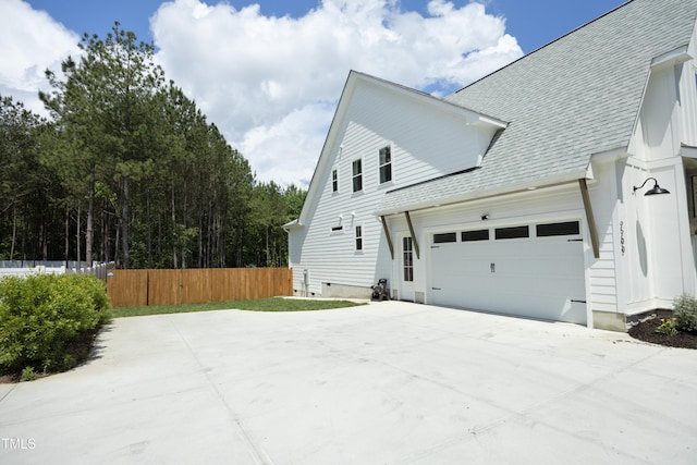 2200 Mays Crossroads Rd, Louisburg, NC 27549 - view of side of property featuring fence, concrete driveway, and roof with shingles