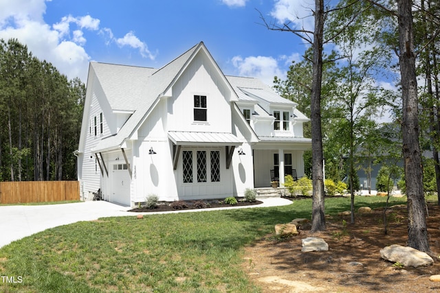 2200 Mays Crossroads Rd, Louisburg, NC 27549 - modern farmhouse featuring a standing seam roof, concrete driveway, an attached garage, covered porch, and metal roof