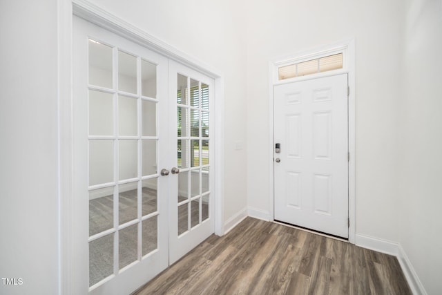 entryway with french doors, baseboards, and wood finished floors