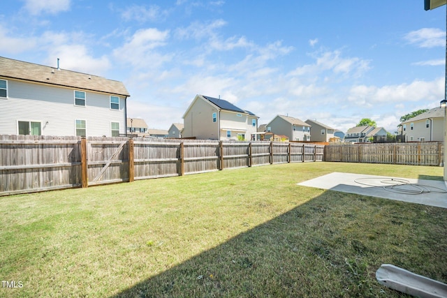 view of yard featuring a residential view and a patio
