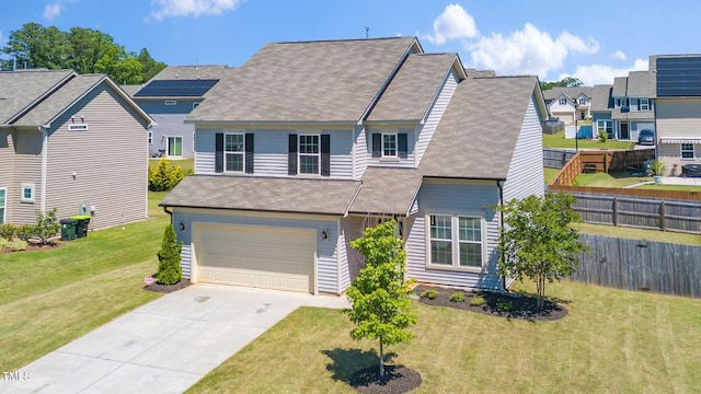 traditional-style house featuring driveway, a garage, a residential view, and a shingled roof