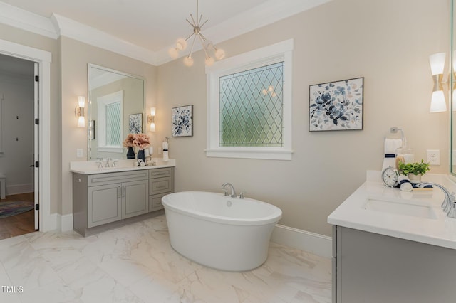 bathroom featuring marble finish floors, a freestanding bath, two vanities, crown molding, and baseboards