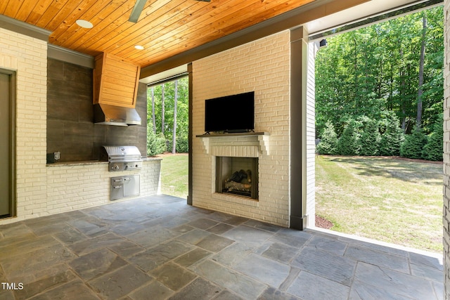 view of patio / terrace with an outdoor brick fireplace, area for grilling, and an outdoor kitchen