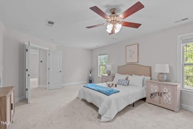 bedroom with light colored carpet, baseboards, and ceiling fan