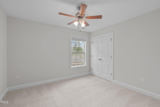 unfurnished bedroom featuring carpet flooring, a closet, and baseboards