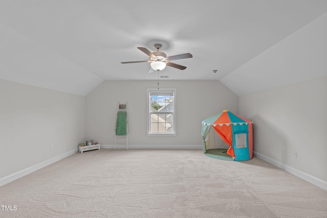 rec room with vaulted ceiling, carpet, a ceiling fan, and baseboards