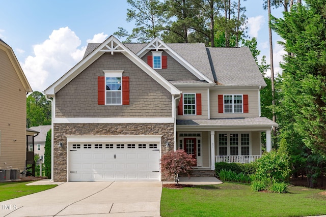 craftsman inspired home featuring driveway, a porch, a front lawn, stone siding, and an attached garage