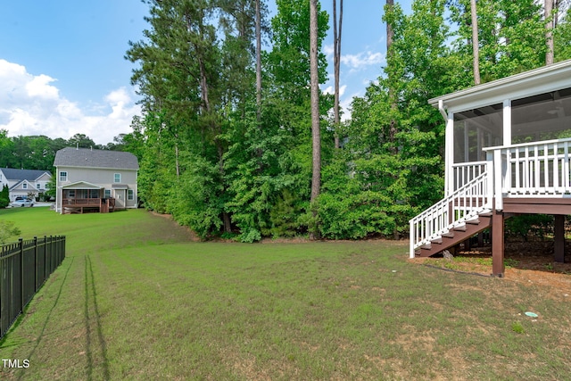 view of yard with a sunroom, stairway, and view of scattered trees