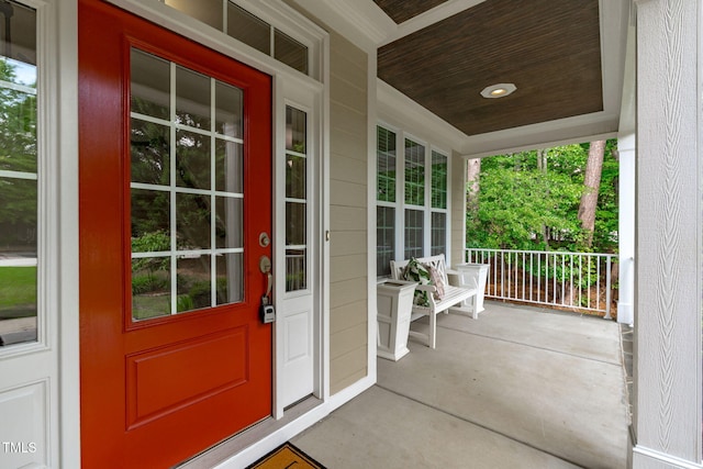 view of exterior entry with covered porch