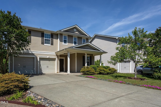 view of front of property with driveway, an attached garage, and a porch