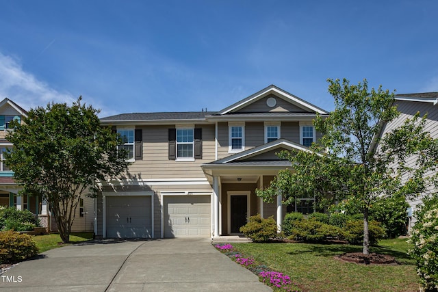 view of front of property with concrete driveway, an attached garage, and a front lawn