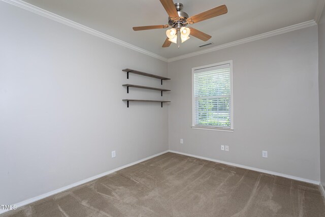 carpeted spare room with a ceiling fan, baseboards, and crown molding