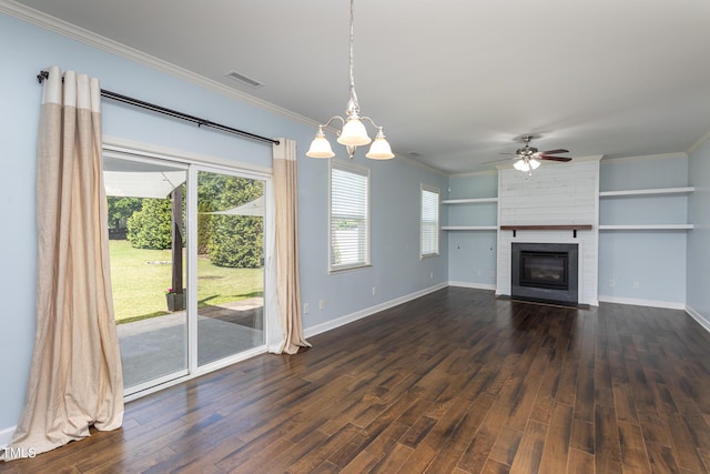 unfurnished living room featuring dark wood-type flooring, ornamental molding, a chandelier, baseboards, and a large fireplace