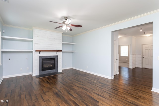 unfurnished living room with a ceiling fan, dark wood-type flooring, crown molding, a fireplace, and baseboards