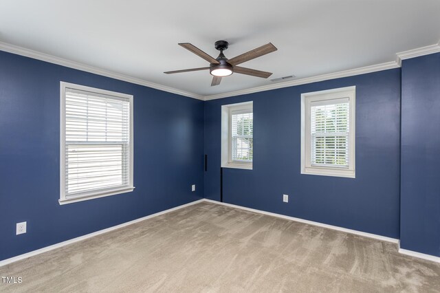 unfurnished room featuring a ceiling fan, carpet, ornamental molding, and baseboards
