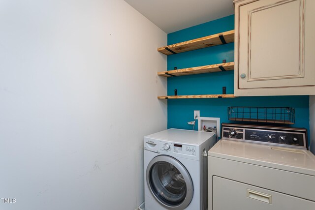 washroom with washing machine and clothes dryer and cabinet space