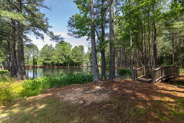 view of yard with a water view and a wooded view