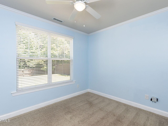 spare room featuring ceiling fan, crown molding, carpet floors, and baseboards