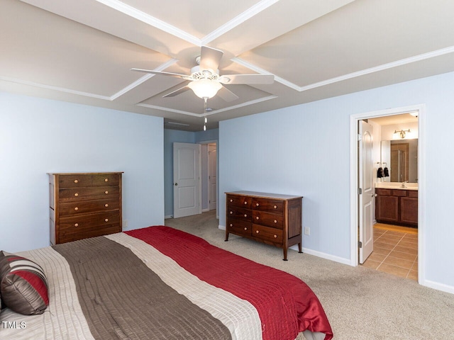 bedroom with light colored carpet, a ceiling fan, baseboards, and ensuite bath