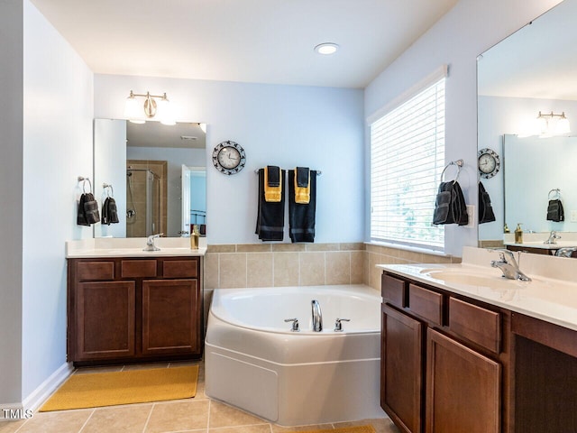 bathroom with a stall shower, a bath, tile patterned flooring, and two vanities