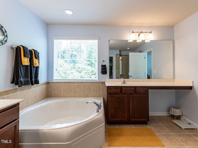 bathroom featuring vanity, a stall shower, a garden tub, and tile patterned flooring