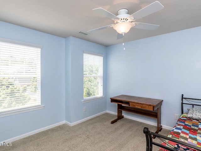 carpeted bedroom featuring baseboards and ceiling fan