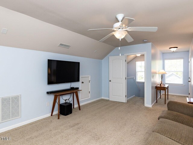 living room with carpet, baseboards, a ceiling fan, and lofted ceiling