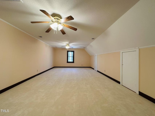 bonus room featuring light carpet, baseboards, ceiling fan, and lofted ceiling